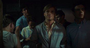 Movie still from “Porky's” (1981), directed by Bob Clark – A group of men standing in the dark; Medium shot, Over the shoulder angle