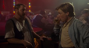 Movie still from “Porky's” (1981), directed by Bob Clark – A man and a woman are talking in a bar; Medium shot, Over the shoulder angle