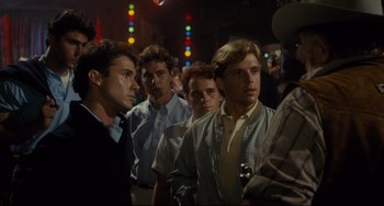 Movie still from “Porky's” (1981), directed by Bob Clark – A group of young men standing next to each other; Medium shot, Over the shoulder angle