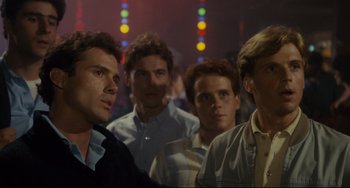 Movie still from “Porky's” (1981), directed by Bob Clark – A group of men standing next to each other in a room; Medium shot, Over the shoulder angle