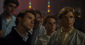 Movie still from “Porky's” (1981), directed by Bob Clark – A group of men standing next to each other in a room; Close Up shot, Low angle
