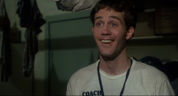 Movie still from “Porky's” (1981), directed by Bob Clark – A young man with a coach shirt on looking up; Close Up shot, Over the shoulder angle