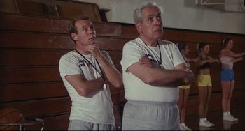 Movie still from “Porky's” (1981), directed by Bob Clark – A couple of men standing next to each other in a gym; Medium shot, Low angle
