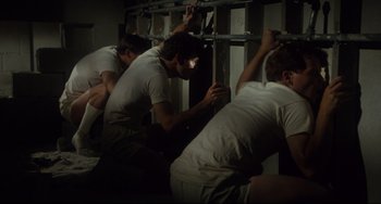 Movie still from “Porky's” (1981), directed by Bob Clark – A group of men standing next to each other in a room; Wide shot, High angle