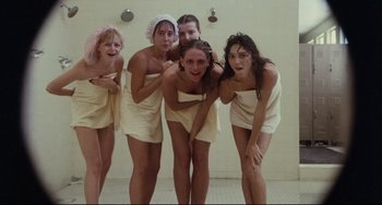 Movie still from “Porky's” (1981), directed by Bob Clark – A group of young women in towels posing for a picture; Medium shot, Overhead angle