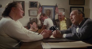 Movie still from “Porky's” (1981), directed by Bob Clark – A group of people sitting around a table; Medium shot, Over the shoulder angle