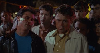 Movie still from “Porky's” (1981), directed by Bob Clark – A group of men standing next to each other in a crowd; Medium shot, Over the shoulder angle