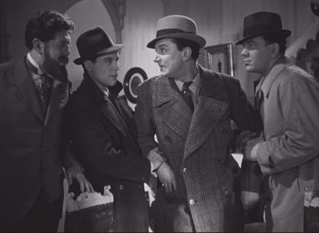 Movie still from “Port of Shadows” (1938), directed by Marcel Carné – A black and white photo of a group of men in hats; Medium shot, Low angle