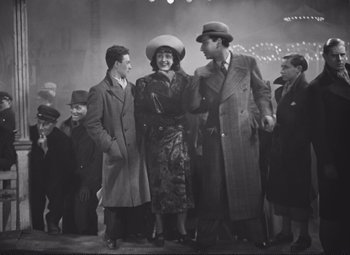 Movie still from “Port of Shadows” (1938), directed by Marcel Carné – A group of men and women standing next to each other; Wide shot, High angle