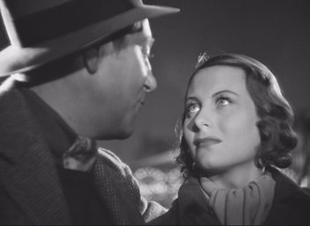 Movie still from “Port of Shadows” (1938), directed by Marcel Carné – A man and a woman looking at one another; Close Up shot, High angle