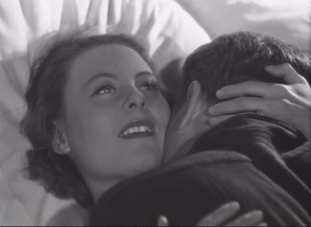 Movie still from “Port of Shadows” (1938), directed by Marcel Carné – A man and a woman embracing each other; Close Up shot, Overhead angle