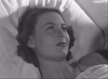 Movie still from “Port of Shadows” (1938), directed by Marcel Carné – A black - and - white photo of a woman laying in bed; Close Up shot, High angle