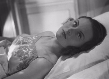Movie still from “Port of Shadows” (1938), directed by Marcel Carné – Black and white photograph of a woman laying on a bed; Close Up shot, High angle