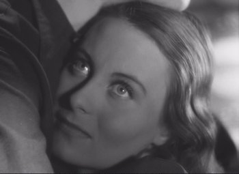Movie still from “Port of Shadows” (1938), directed by Marcel Carné – A black - and - white photo of a woman's face; Close Up shot, High angle