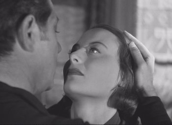 Movie still from “Port of Shadows” (1938), directed by Marcel Carné – A man and a woman looking into each others eyes; Close Up shot, High angle