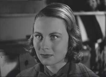 Movie still from “Port of Shadows” (1938), directed by Marcel Carné – An old photo of a woman in a suit; Close Up shot, High angle