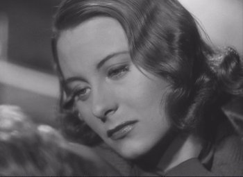 Movie still from “Port of Shadows” (1938), directed by Marcel Carné – An old black and white photo of a woman; Close Up shot, Low angle