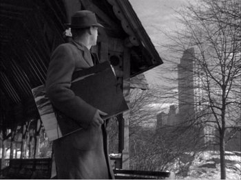 Movie still from “Portrait of Jennie” (1948), directed by William Dieterle – A black and white photo of a man holding a briefcase; Medium shot, Low angle