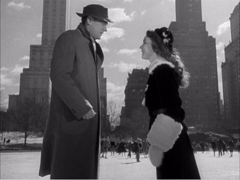 Movie still from “Portrait of Jennie” (1948), directed by William Dieterle – An old photo of a man and a woman talking to each other; Medium shot, Low angle