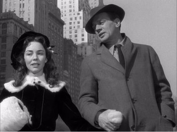 Movie still from “Portrait of Jennie” (1948), directed by William Dieterle – A man and a woman walking in the street; Medium shot, Low angle