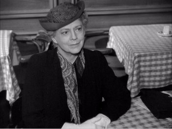 Movie still from “Portrait of Jennie” (1948), directed by William Dieterle – An older woman sitting at a table in a restaurant; Close Up shot, Over the shoulder angle