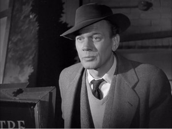 Movie still from “Portrait of Jennie” (1948), directed by William Dieterle – A man wearing a suit and a hat in a black and white photo; Close Up shot, Low angle