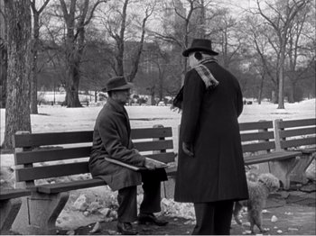 Movie still from “Portrait of Jennie” (1948), directed by William Dieterle – Two men sitting on a park bench talking to each other; Wide shot, Over the shoulder angle