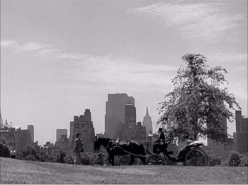 Movie still from “Portrait of Jennie” (1948), directed by William Dieterle – A horse drawn carriage in the middle of a city; Extreme Wide shot, High angle