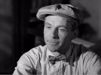 Movie still from “Portrait of Jennie” (1948), directed by William Dieterle – A black and white photo of a man wearing a bow tie; Close Up shot, High angle