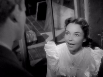 Movie still from “Portrait of Jennie” (1948), directed by William Dieterle – A black - and - white photo of a woman holding a napkin; Close Up shot, High angle