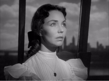 Movie still from “Portrait of Jennie” (1948), directed by William Dieterle – Black and white photograph of a woman in a white dress; Close Up shot, Low angle