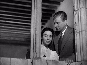Movie still from “Portrait of Jennie” (1948), directed by William Dieterle – A man and a woman standing next to each other in front of a window; Medium shot, Over the shoulder angle
