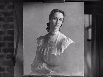 Movie still from “Portrait of Jennie” (1948), directed by William Dieterle – An old photo of a woman wearing a white dress; Close Up shot, Overhead angle