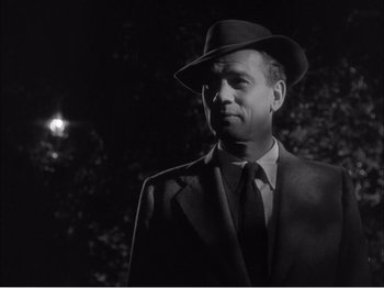 Movie still from “Portrait of Jennie” (1948), directed by William Dieterle – A black and white photo of a man wearing a suit and a hat; Close Up shot, Low angle