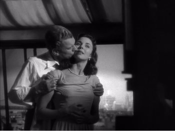 Movie still from “Portrait of Jennie” (1948), directed by William Dieterle – A man and a woman are kissing in a black and white photo; Medium shot, Low angle