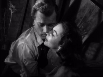 Movie still from “Portrait of Jennie” (1948), directed by William Dieterle – A man and a woman kissing in a black and white photo; Close Up shot, High angle