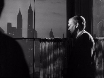 Movie still from “Portrait of Jennie” (1948), directed by William Dieterle – A black and white photo of a man looking out of a window; Medium shot, Low angle