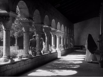 Movie still from “Portrait of Jennie” (1948), directed by William Dieterle – A black - and - white photo of an indoor courtyard; Extreme Wide shot, High angle
