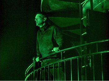 Movie still from “Portrait of Jennie” (1948), directed by William Dieterle – A man standing on top of a railing at night; Medium shot, Low angle