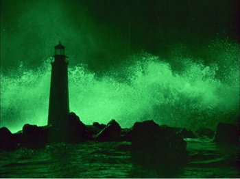 Movie still from “Portrait of Jennie” (1948), directed by William Dieterle – A light house in the middle of the night with waves crashing behind it; Extreme Wide shot, Low angle