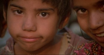 Movie still from “Powaqqatsi” (1988), directed by Godfrey Reggio – A child's eyes and face; Extreme Close Up shot, High angle