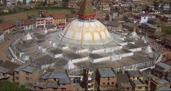 Movie still from “Powaqqatsi” (1988), directed by Godfrey Reggio – An aerial view of a temple in the middle of a city; Extreme Wide shot, Overhead angle