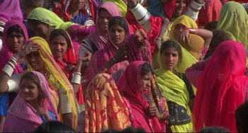 Movie still from “Powaqqatsi” (1988), directed by Godfrey Reggio – A group of women in brightly - colored clothes; Medium shot, High angle