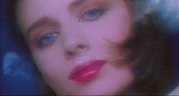Movie still from “Powaqqatsi” (1988), directed by Godfrey Reggio – A woman's eyes and lips; Extreme Close Up shot, Low angle