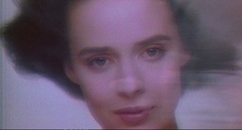Movie still from “Powaqqatsi” (1988), directed by Godfrey Reggio – A woman with brown eyes and a black hair style; Extreme Close Up shot, High angle
