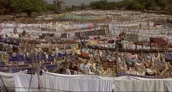 Movie still from “Powaqqatsi” (1988), directed by Godfrey Reggio – A lot of clothes hanging out to dry in the sun; Extreme Wide shot, High angle