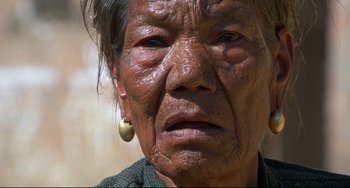 Movie still from “Powaqqatsi” (1988), directed by Godfrey Reggio – An old woman with a very large nose ring; Extreme Close Up shot, Low angle