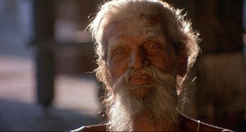 Movie still from “Powaqqatsi” (1988), directed by Godfrey Reggio – An old man with white hair and a long beard; Close Up shot, Low angle