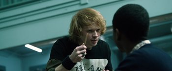 Movie still from “Power Rangers” (2017), directed by Dean Israelite – A young man holding a wooden stick in his hand; Close Up shot, Over the shoulder angle