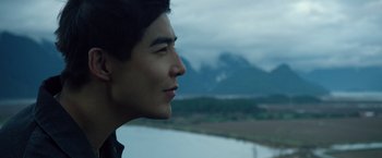 Movie still from “Power Rangers” (2017), directed by Dean Israelite – A man looking out over a body of water; Close Up shot, Over the shoulder angle